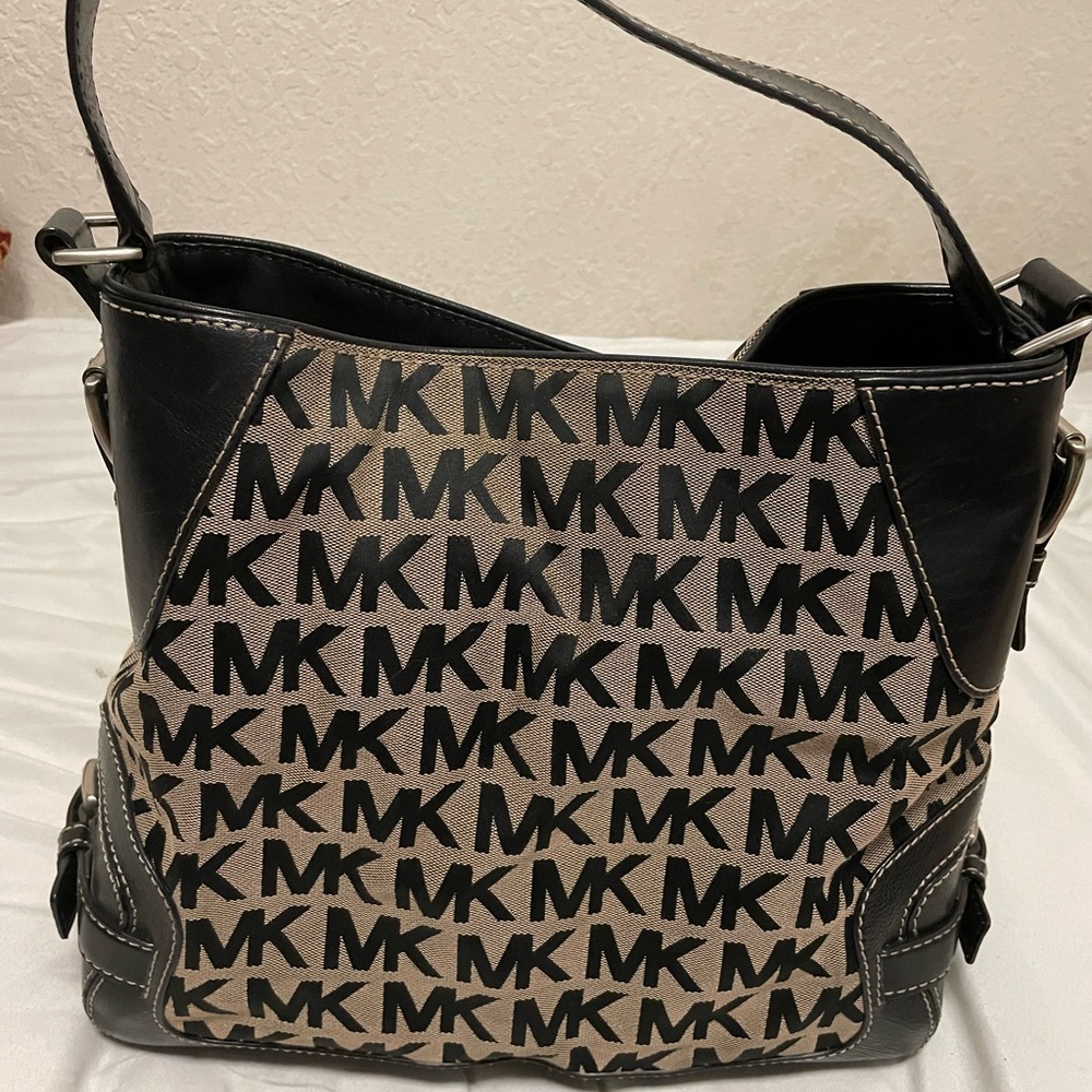 Michael Kors black leather handbag with MK initials all over it
